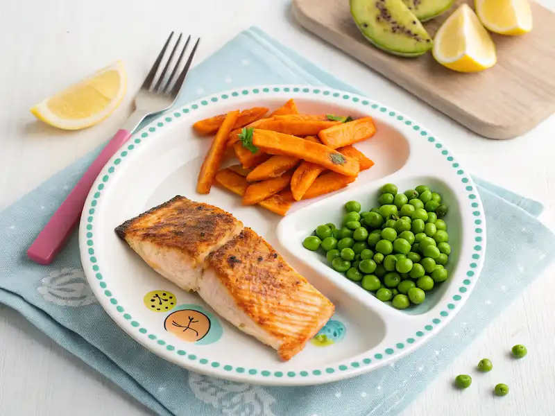 Oven-baked salmon with crispy sweet potato fries – kid-friendly paleo dinner plate.