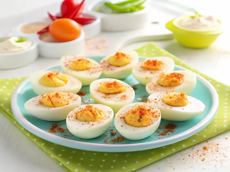 Hard-Boiled Egg Halves with Paprika—simple and protein-rich toddler snacks topped with a dash of paprika for flavor and color.
